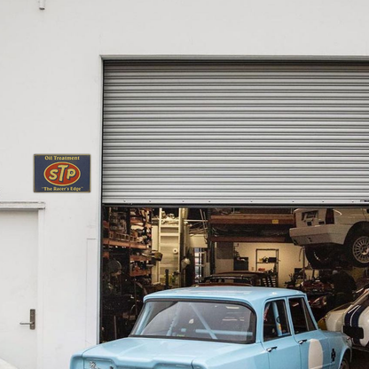 STP Oil Treatment – “The Racer’s Edge” Tin Sign